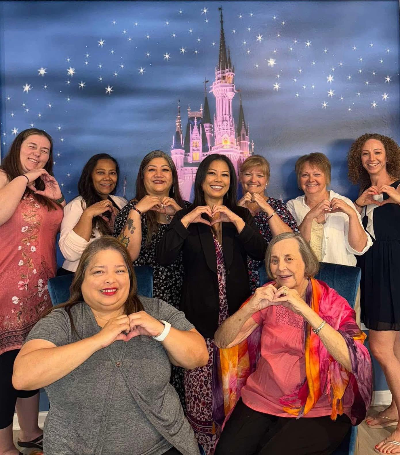 Past retreat participants making heart signs together